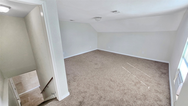 additional living space with lofted ceiling and carpet floors