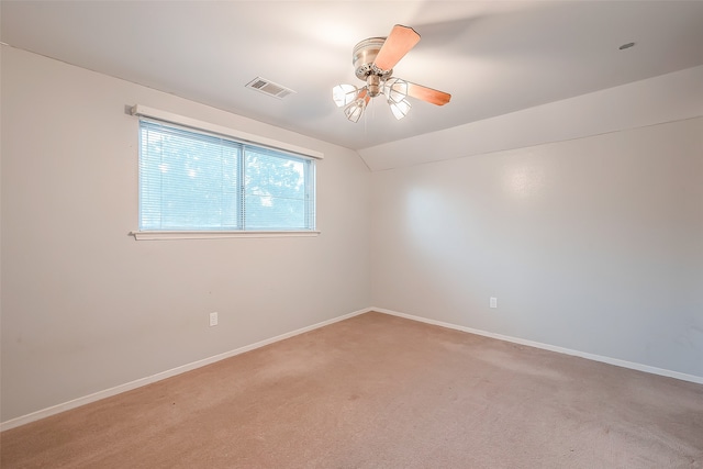 unfurnished room featuring carpet flooring, vaulted ceiling, and ceiling fan