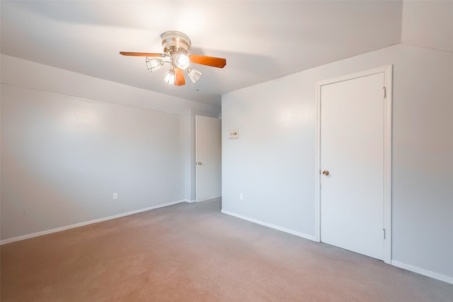 unfurnished room featuring ceiling fan and light carpet