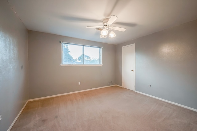 unfurnished room featuring light carpet and ceiling fan