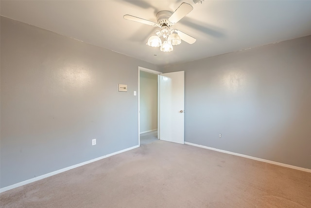 spare room featuring light colored carpet and ceiling fan