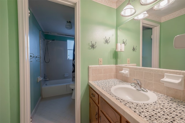 full bathroom with tile patterned floors, toilet, backsplash, vanity, and washtub / shower combination