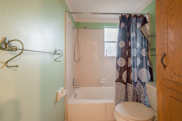 bathroom with crown molding, shower / bath combination with curtain, and toilet