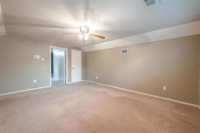 carpeted spare room with vaulted ceiling and ceiling fan