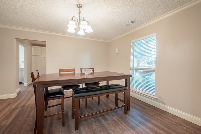 dining area with crown molding, a notable chandelier, a textured ceiling, and dark hardwood / wood-style flooring