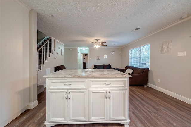 kitchen with dark wood-type flooring, white cabinets, and a kitchen island