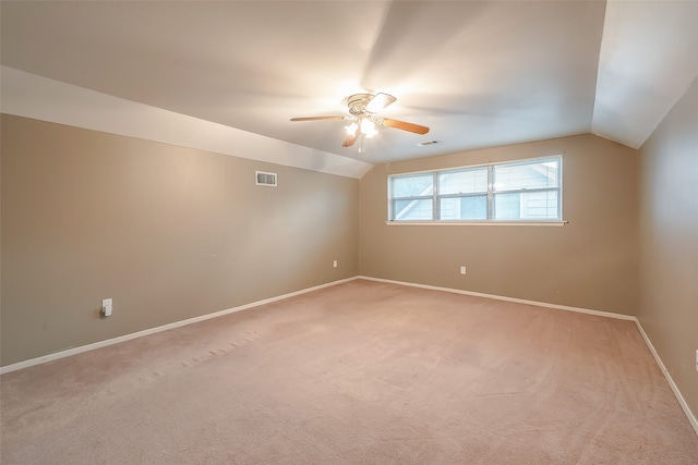 carpeted empty room featuring ceiling fan and vaulted ceiling