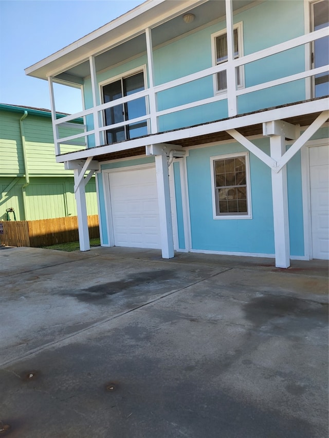 view of home's exterior featuring a balcony and a garage