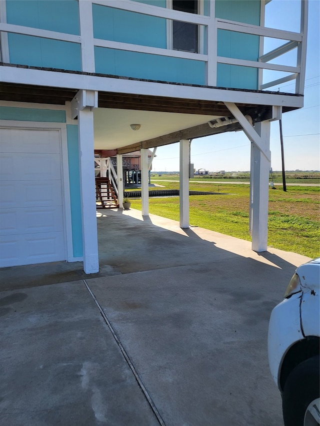 view of patio / terrace with a rural view and a garage