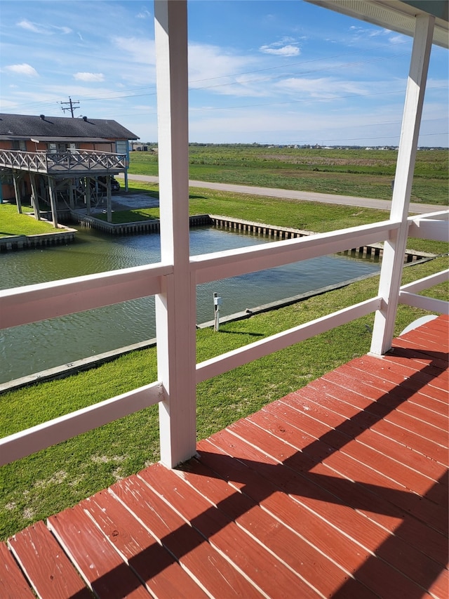 exterior space featuring a lawn and a water view