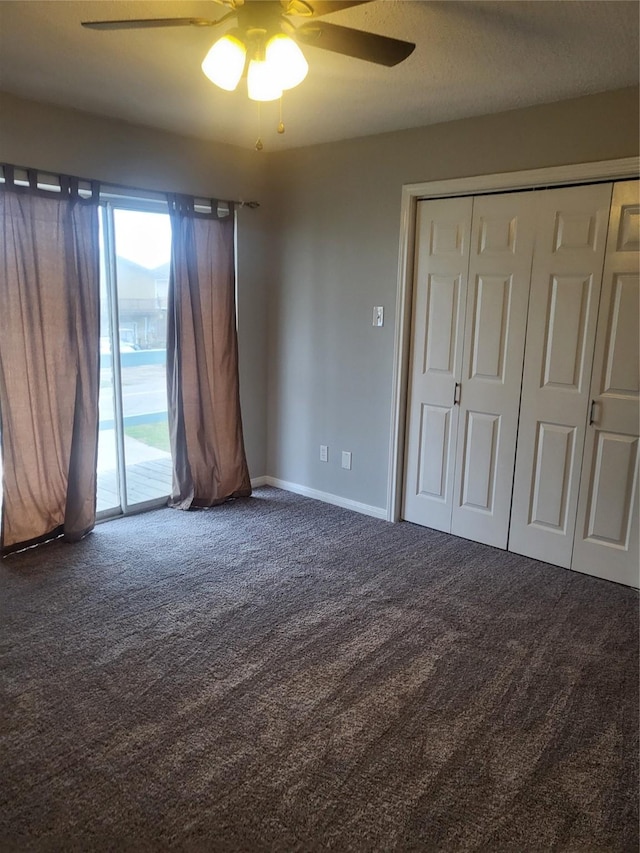 unfurnished bedroom with ceiling fan, access to exterior, carpet floors, and a closet