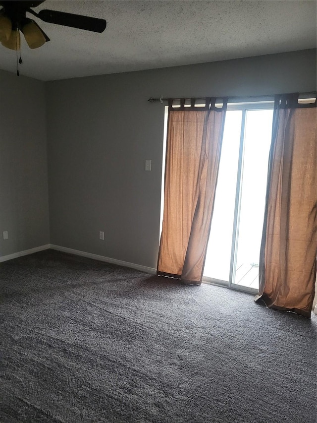 spare room featuring carpet, ceiling fan, and a textured ceiling