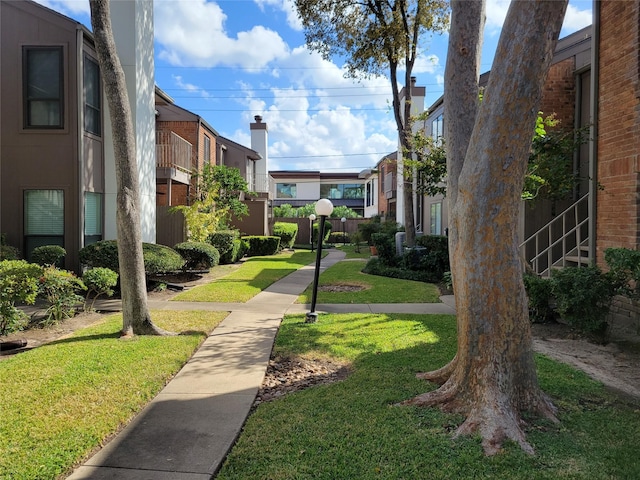 view of property's community featuring a residential view and a yard