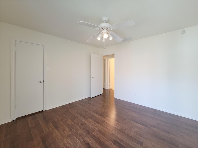 spare room featuring baseboards, a ceiling fan, and wood finished floors