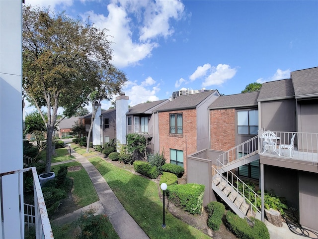 view of property's community featuring stairway and a residential view