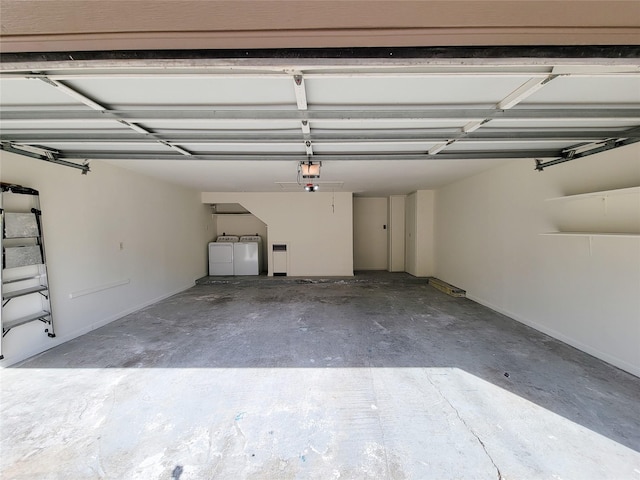 garage with washer and dryer and a garage door opener