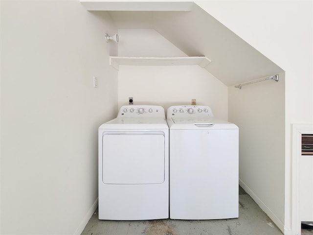 clothes washing area featuring washing machine and dryer, laundry area, and baseboards