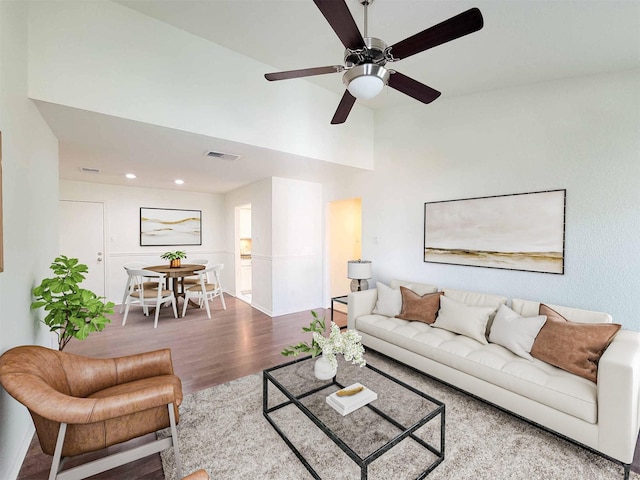 living room with ceiling fan, vaulted ceiling, visible vents, recessed lighting, and wood finished floors