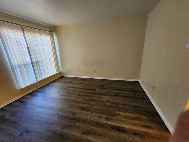 unfurnished room featuring dark hardwood / wood-style flooring