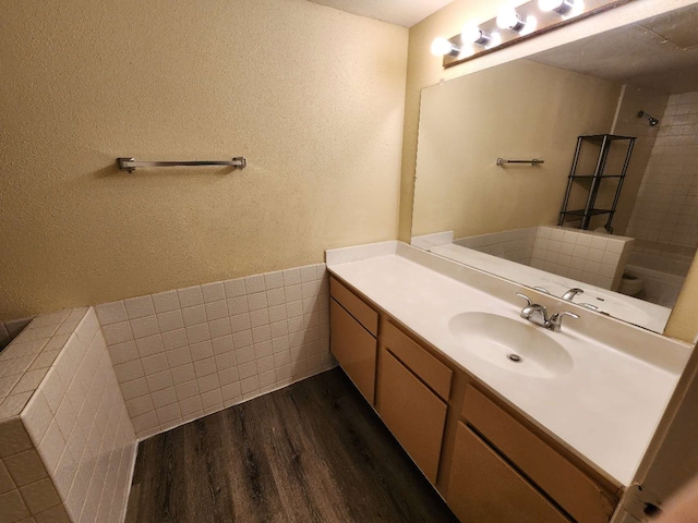 bathroom with vanity, hardwood / wood-style flooring, and walk in shower