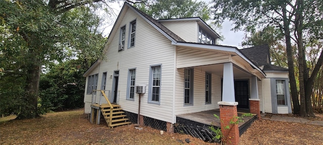 view of home's exterior featuring cooling unit and covered porch