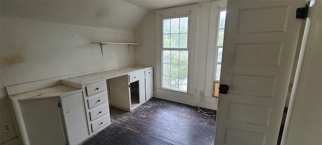 unfurnished office with lofted ceiling, dark wood-type flooring, and plenty of natural light