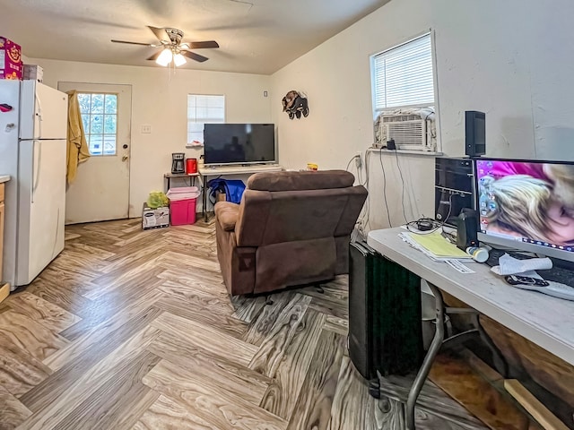 living room featuring ceiling fan, a healthy amount of sunlight, cooling unit, and light parquet floors