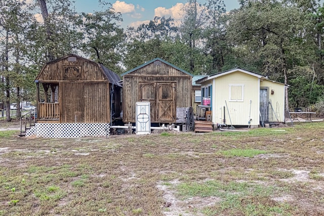 rear view of property featuring a yard and a shed