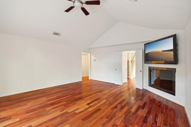 unfurnished living room featuring lofted ceiling, hardwood / wood-style flooring, and ceiling fan