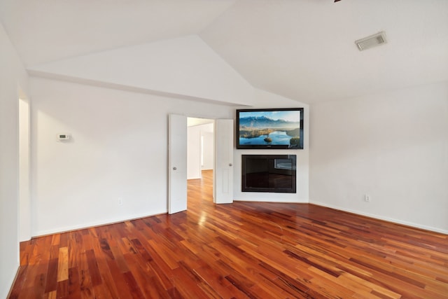 unfurnished living room featuring wood-type flooring and vaulted ceiling