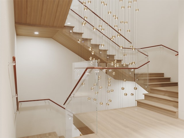 stairway featuring hardwood / wood-style flooring and wood ceiling