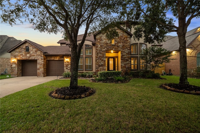 view of front of house with a yard and a garage