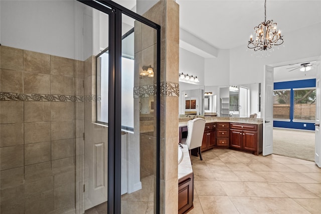 bathroom with vanity, walk in shower, tile patterned floors, and ceiling fan with notable chandelier