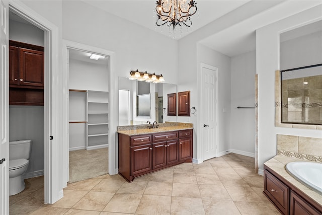 full bathroom with tile patterned floors, toilet, separate shower and tub, an inviting chandelier, and vanity