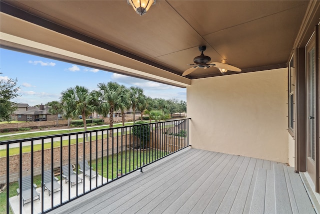 deck featuring a yard and ceiling fan