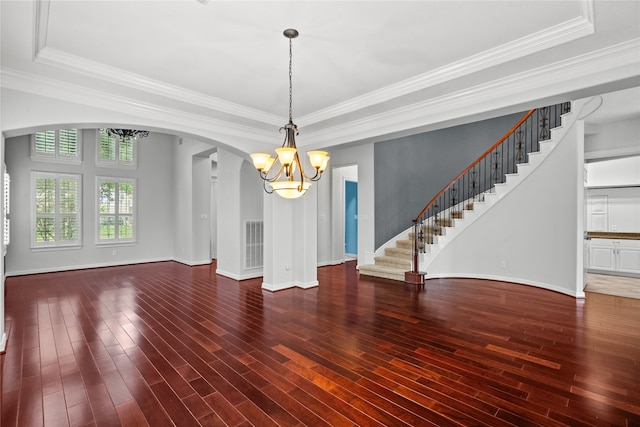 unfurnished dining area featuring ornamental molding, hardwood / wood-style floors, and a tray ceiling