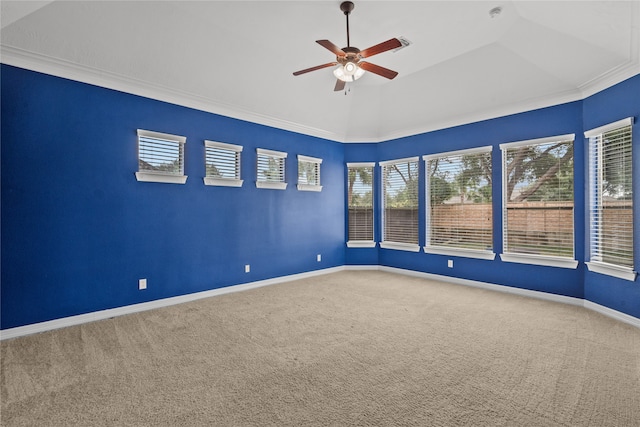 carpeted empty room with ornamental molding, ceiling fan, lofted ceiling, and plenty of natural light