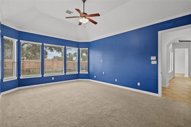 empty room with ornamental molding, carpet, lofted ceiling, and ceiling fan