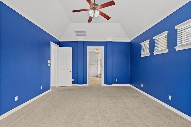 unfurnished bedroom featuring ceiling fan, carpet flooring, ornamental molding, and vaulted ceiling