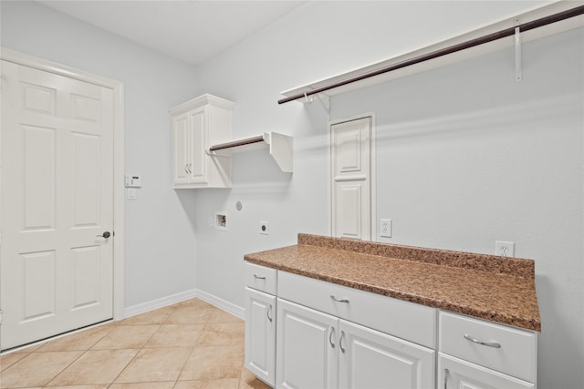 laundry room with cabinets, hookup for a washing machine, light tile patterned floors, and electric dryer hookup