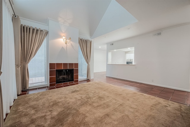 unfurnished living room featuring tile patterned floors, crown molding, and a fireplace