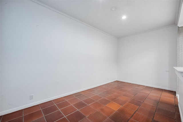 tiled spare room featuring ornamental molding