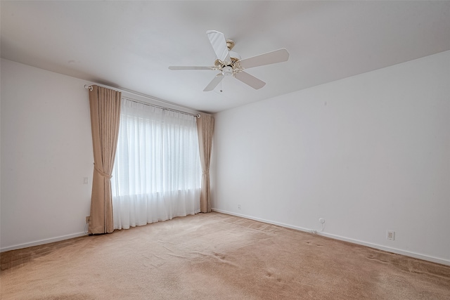 empty room with light carpet and ceiling fan