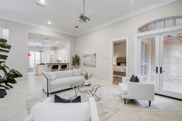 tiled living room with ornamental molding, ceiling fan, and french doors