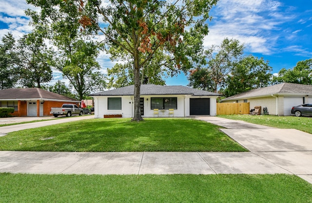 ranch-style house featuring a front yard and a garage