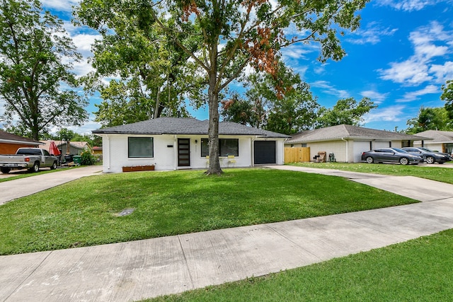 ranch-style home featuring a front yard and a garage