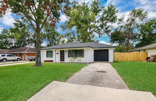 single story home with a front yard and a garage