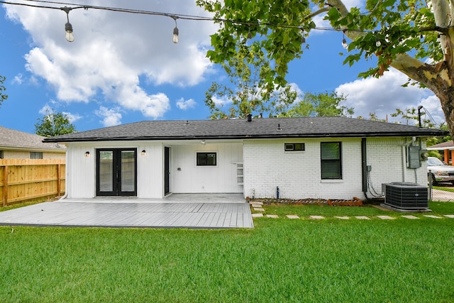 back of property featuring a deck, a yard, and central AC unit