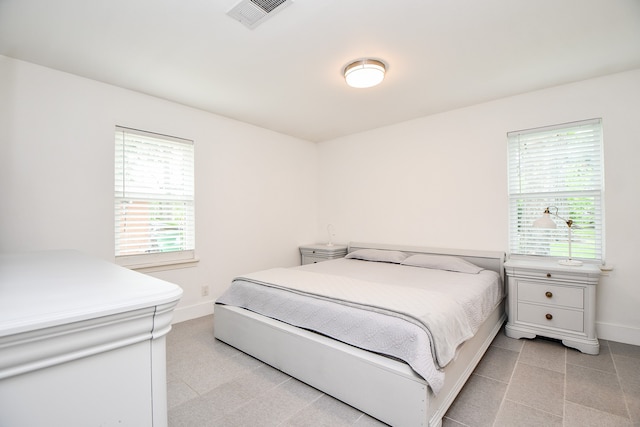 bedroom with multiple windows