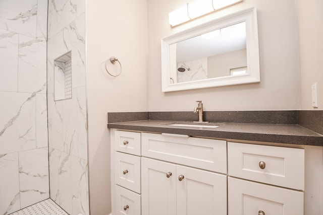 bathroom featuring vanity and a tile shower